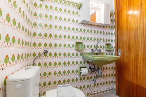a bathroom with a toilet and a sink at Mires House Apartment 11 in Agios Gordios