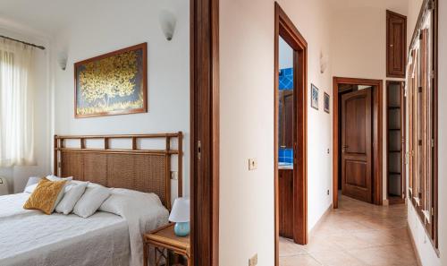 a bedroom with a bed and a mirror at Villa Mistral in Costa Rei