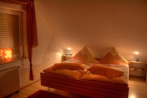 a bedroom with a bed with pillows and a window at Haus Wehrle in Breisach am Rhein