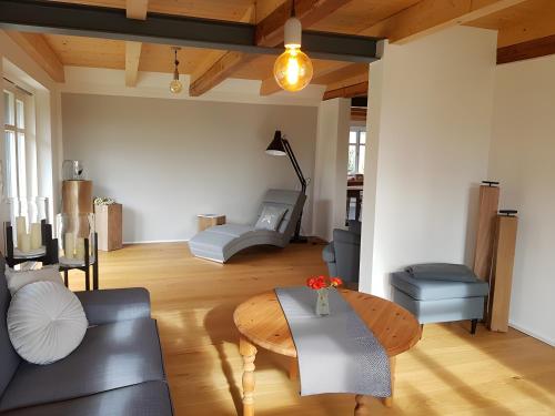 a living room with a couch and a table at Schäferhaus in Hemme