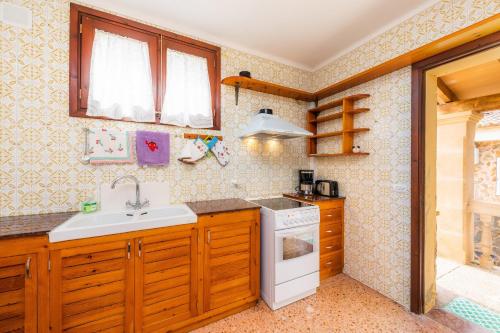 a kitchen with a sink and a stove at Casa Isabel y Mateo in Cala de Sant Vicenc