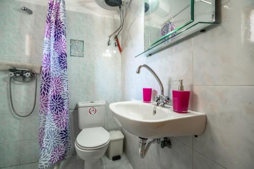 a bathroom with a sink and a toilet and a shower at Marketos studio 2 in Kefallonia