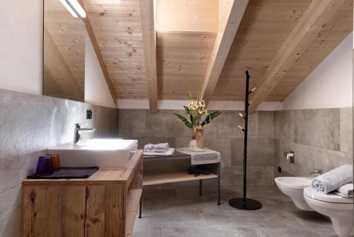 a bathroom with a sink and a toilet at Living Lerchna - Schöne Aussicht in Maranza