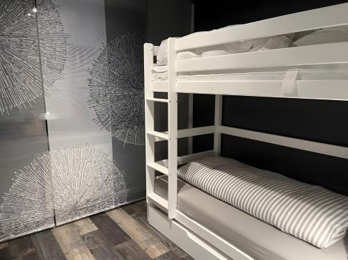 a white bunk bed in a room with a wall at Haus Blumenglück in Herscheid