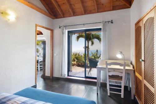a bedroom with a desk and a view of the ocean at Las Vetas in Tijarafe