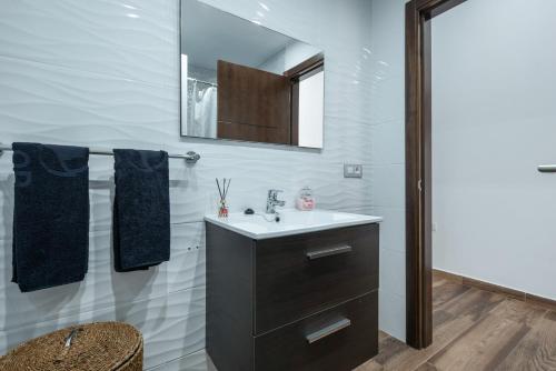 a bathroom with a sink and a mirror at Finca Aramai in Adeje
