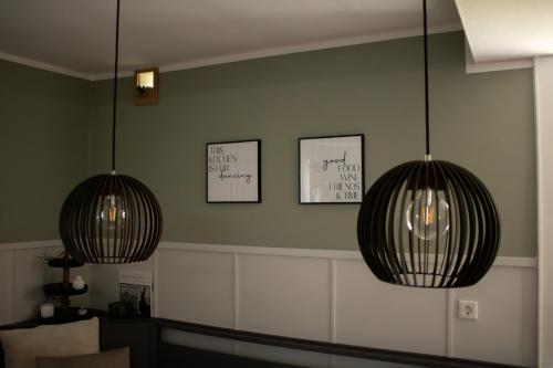 two lights hanging from a wall in a room at Ferienhaus Hallmanns Hof in Schmallenberg