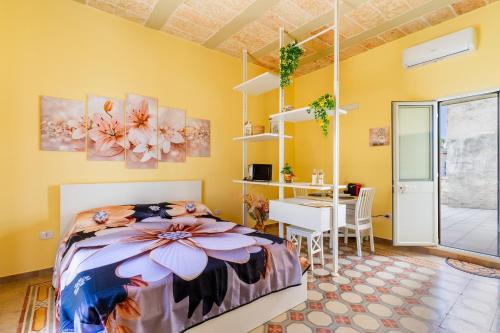 a bedroom with a bed and a table and a desk at Casa donna Sofia in Specchia