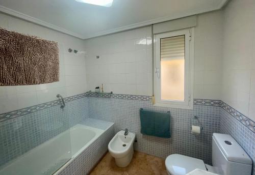 a bathroom with a tub and a toilet and a sink at Relax Inn in Pilar de la Horadada