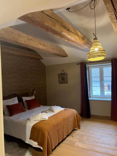 a bedroom with a large bed in a room at La Cure Vosgienne in Champdray