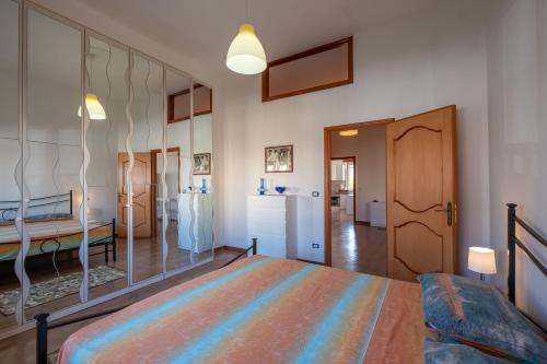 a bedroom with a bed with a large mirror at Casa Ginevra Salento in San Cassiano