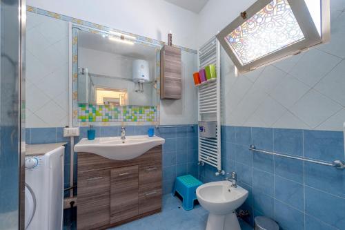 a bathroom with a sink and a toilet and a mirror at Dimora storica monteroni di lecce in Monteroni di Lecce