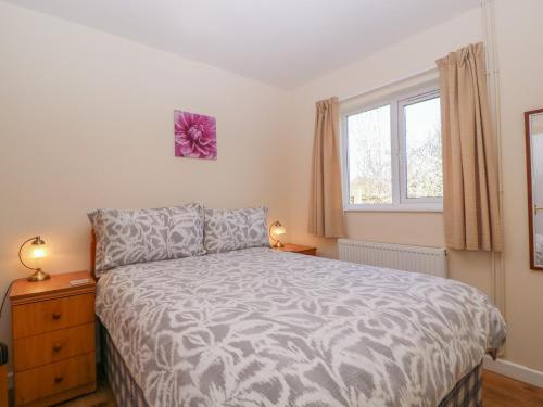 a bedroom with a bed and a window at The Turbles - Swallows Nest in Castlemorton