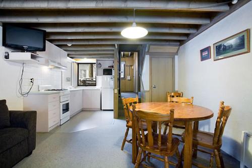 a kitchen and dining room with a table and chairs at Battys in Dinner Plain