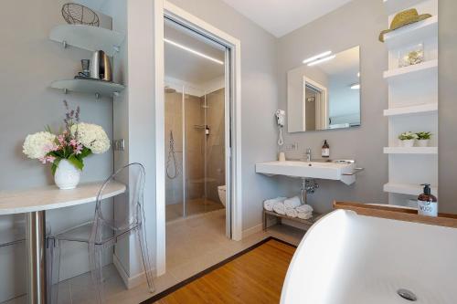 a bathroom with a sink and a mirror at Eco del Garda Apartments in Tenno