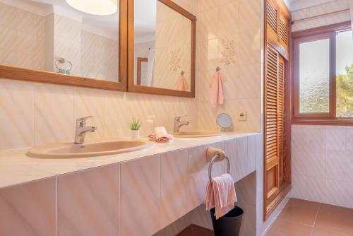 a bathroom with a sink and a mirror at Can Cancus in Capdepera