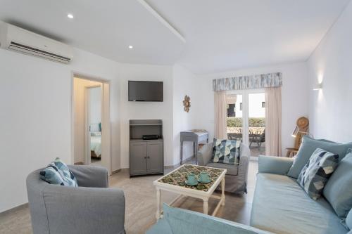 a living room with a couch and a table at Villa Isabel in Vale do Lobo