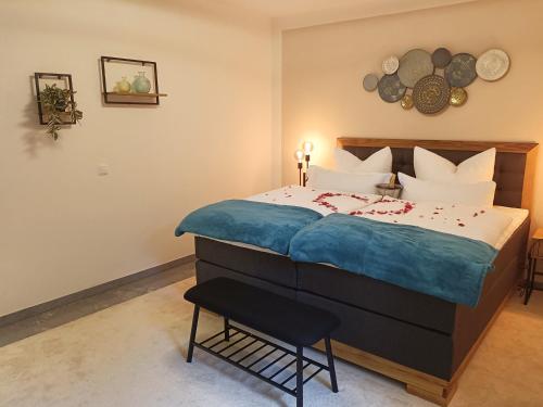 a bedroom with a bed and a chair in it at Wohlfühloase Ermreuth in Neunkirchen am Brand