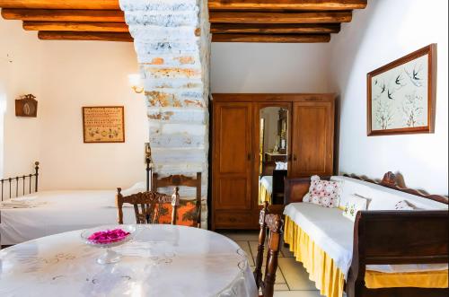 a bedroom with two beds and a table in a room at Zeus House in Naxos Chora