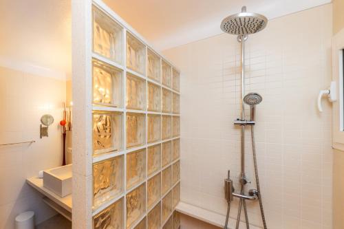 a bathroom with a shower with a tile wall at Es Claper in Cala Ratjada