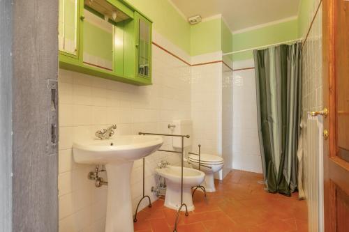 a bathroom with a sink and a toilet at Universal Harmony - Nibbio in Dicomano