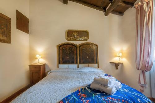 a bedroom with a large bed with a blue blanket at Universal Harmony - Nibbio in Dicomano