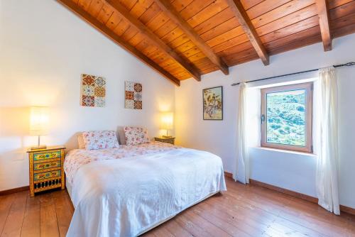 a bedroom with a bed and a window at Finca Las Nuevas Casa Carmen in Alora