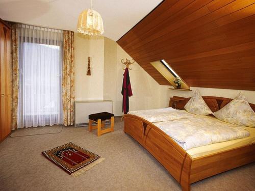 a bedroom with a large bed in a room at Haus Margot Armbruster in Bad Rippoldsau-Schapbach