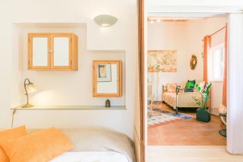 a bedroom with a bed and a living room at Canto do Sol - Selão da Eira in Pedreneiras