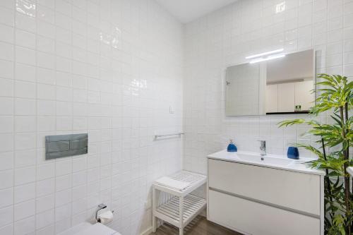 a white bathroom with a sink and a mirror at Aveiro City Blue in Aveiro