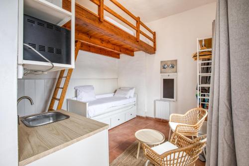 a small kitchen with a sink and a microwave at Casa Mathilda in Calonge