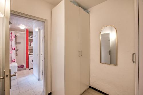 a hallway with a bathroom with a mirror on the wall at Casa Mathilda in Calonge