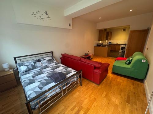 a living room with a bed and a couch at Cardiff City Escapes in Cardiff