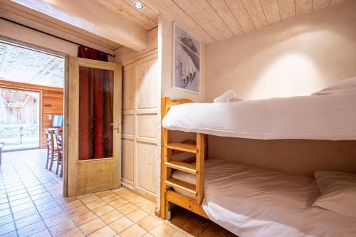 En eller flere senge i et værelse på Appartement Flocon