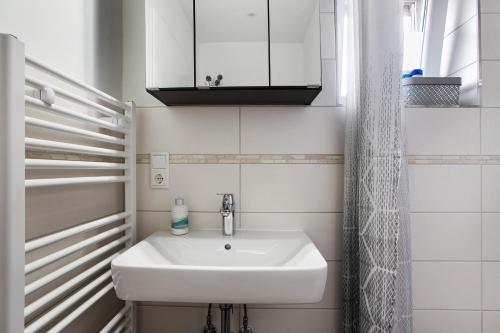 a bathroom with a white sink and a mirror at Kompass Oase in Burg