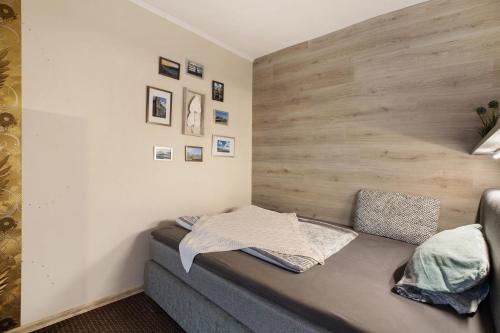 a couch in a room with a wooden wall at Kompass Oase in Burg