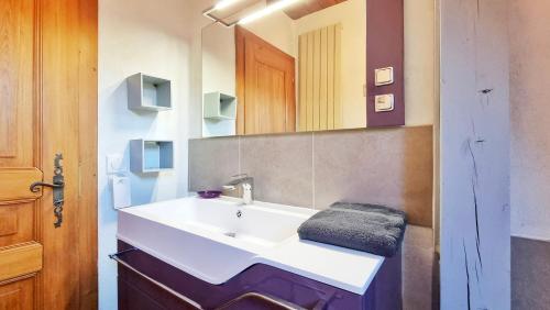 a bathroom with a white sink and a mirror at Albert Ranch House - Grande maison au calme - Parking in Ribeauvillé