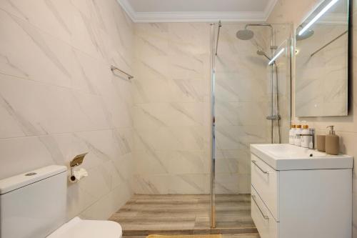 a bathroom with a shower and a toilet and a sink at Yasmim House in Sagres