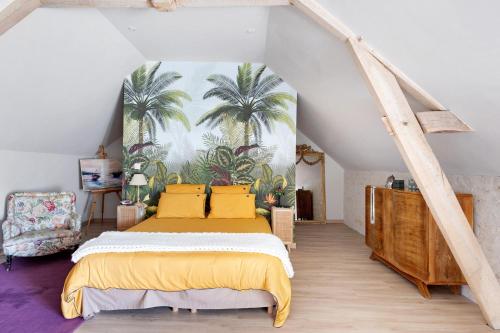 a bedroom with a bed and a mural of palm trees at Chambre Terracotta in Tavant