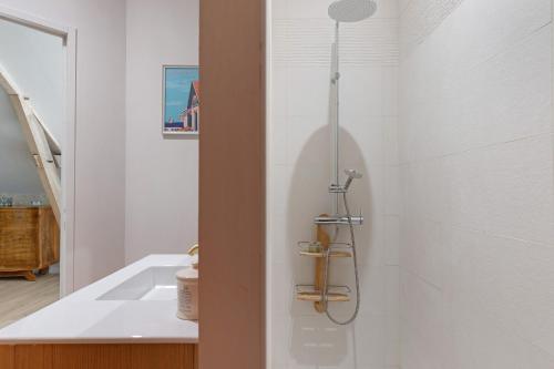a bathroom with a shower and a sink at Chambre Terracotta in Tavant