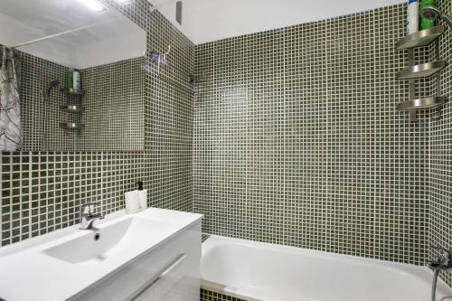 a bathroom with a sink and a tub and a toilet at Oramas Beach House – Pool & Terrace in Puertito de Güímar