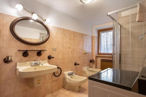 a bathroom with a sink and a toilet and a mirror at Il Borgo - Aymavilles in Aymavilles