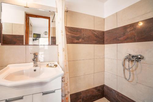 a bathroom with a sink and a shower at Panorama Tilos Apt A in Tílos