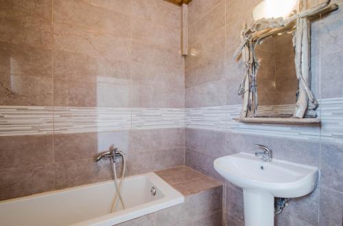 a bathroom with a sink and a bath tub at Mirage Arillas Studio Type B11 in Arillas