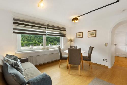 a living room with a table and chairs and a window at Schwalbennest in Lennestadt