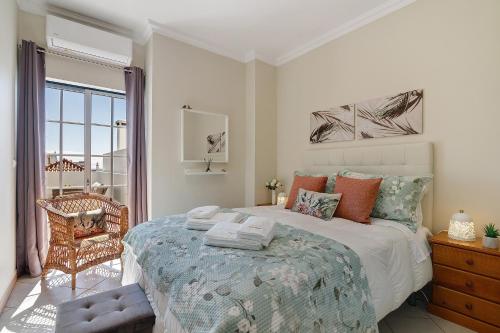 a bedroom with a large bed and a window at Ria's Birds in Cabanas de Tavira