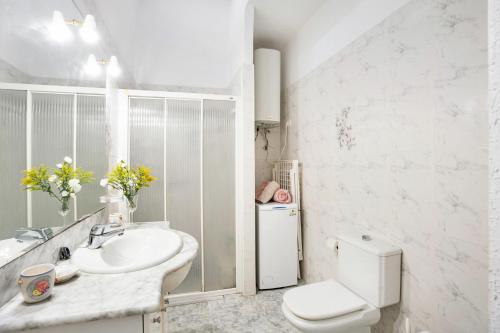 a white bathroom with a sink and a toilet at Apartamento Poris in Arico