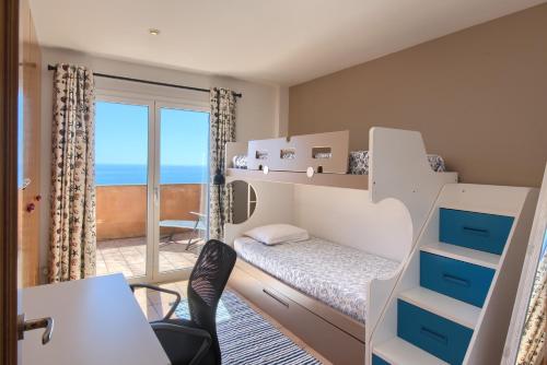 a bedroom with a bunk bed with a view of the ocean at Casa Marbello - Begur in Begur