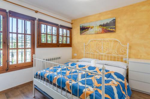 a bedroom with a bed in a room with windows at Allotjament Bogues in Lloret de Mar