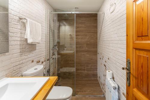 a bathroom with a shower and a toilet and a sink at Allotjament Bogues in Lloret de Mar